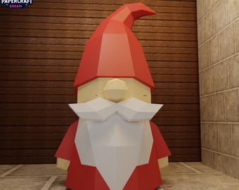 May include: A papercraft gnome figure with a red hat and coat, a white beard, and a beige face. The figure is standing on a tiled surface. The Papercraft Dream logo is in the upper left corner.