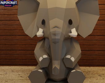 May include: A geometric papercraft elephant in shades of gray, with large ears and tusks. The elephant is sitting, with its legs folded. The Papercraft Dream logo is in the upper left corner, featuring a colorful owl.