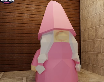 May include: A pink papercraft gnome with a pointed hat and long braids. The gnome is wearing a pink dress and has a geometric design. The Papercraft Dream logo is in the upper left corner.