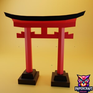 May include: A red and black papercraft Torii gate, a traditional Japanese Shinto shrine gate. The gate has two vertical pillars and a horizontal beam, with a black top. The gate is set on two black rectangular bases.