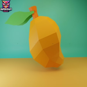 May include: A geometric, orange mango with a green leaf and orange stem. The mango is set against a teal background and a yellow-orange surface. The logo "PAPERCRAFT DREAM" is in the upper left corner.