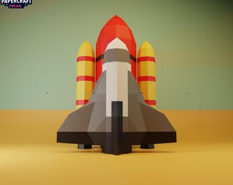 May include: A low-poly papercraft model of a space shuttle, featuring a red and white body with yellow boosters. The shuttle is set against a yellow and green gradient background. The Papercraft Dream logo is in the top left corner.
