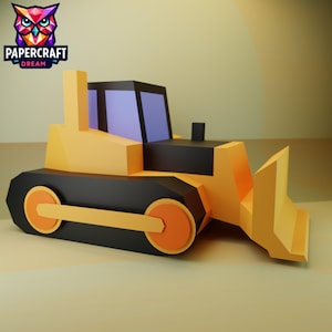 Op de afbeelding: Een gele en zwarte papieren bulldozer met oranje wielen en een voorblad. De bulldozer heeft een zwarte cabine met een paarse ruit. Het logo "PAPERCRAFT DREAM" staat in de linkerbovenhoek.