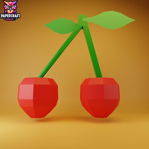 May include: A 3D rendering of two red cherries with green stems and leaves. The cherries have a faceted design, and the background is a warm, golden colour. The logo "PAPERCRAFT DREAM" is in the upper left corner.
