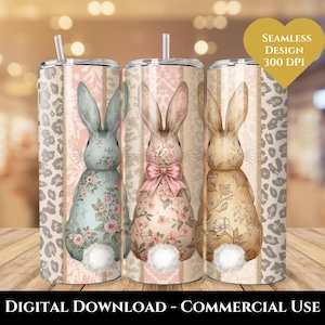 May include: Three stainless steel tumblers with bunny designs. Each tumbler features a different bunny illustration with floral patterns and a fluffy white tail. The background includes a leopard print and striped design. The text "SEAMLESS DESIGN 300 DPI" is visible.