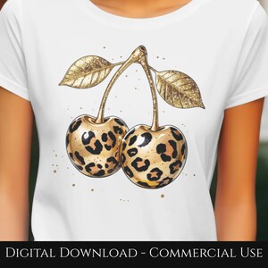 May include: White t-shirt featuring a gold-colored illustration of two cherries with leopard print patterns. The cherries have gold stems and leaves. The text "DIGITAL DOWNLOAD - COMMERCIAL USE" is at the bottom.