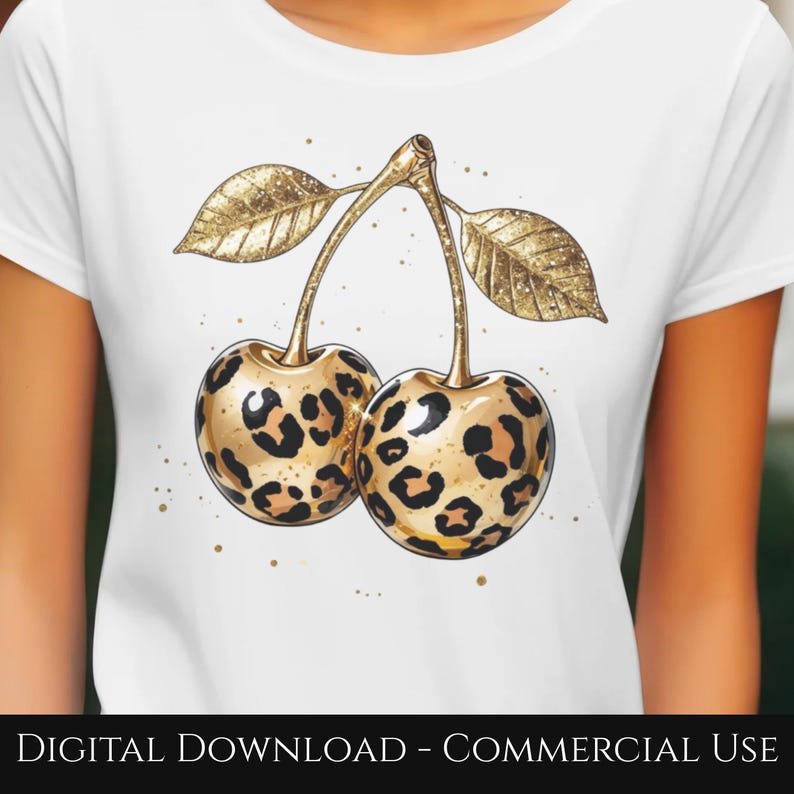 May include: White t-shirt featuring a gold-colored illustration of two cherries with leopard print patterns. The cherries have gold stems and leaves. The text "DIGITAL DOWNLOAD - COMMERCIAL USE" is at the bottom.
