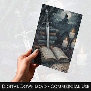 May include: A fantasy-themed print featuring a sword piercing a stack of books, with an open book in the foreground. The background shows a castle, candles, and a full moon. The print has a dark, gothic aesthetic.