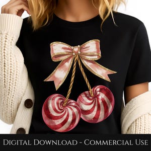 May include: Black t-shirt featuring a digital illustration of two red and white striped cherries hanging from a pink bow with gold accents. The text "DIGITAL DOWNLOAD - COMMERCIAL USE" is at the bottom of the image.