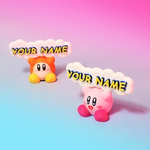 May include: Two pink and orange cartoon characters holding up white clouds with the text "YOUR NAME" in yellow letters with blue outlines.