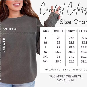 May include: A size chart for a Comfort Colors 1566 adult crewneck sweatshirt. The chart shows measurements in inches for sizes S to 3XL. The sweatshirt is a muted green color. The text "Comfort Colors" is at the top.