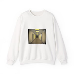 May include: A white long-sleeve crewneck sweatshirt featuring a rectangular graphic print of a dimly lit, yellow-toned hallway with fluorescent ceiling lights. Below the image, the text reads: YOU WERE NOT CLEANED FOR THIS LEVEL.