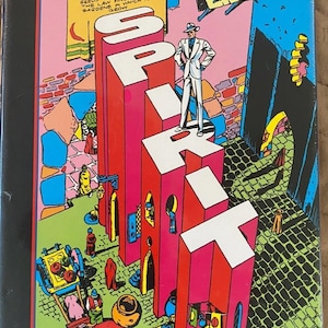 May include: A colorful comic book cover for "Will Eisner's Spirit Archives." The cover features the word "SPIRIT" in large, stylized letters, with a figure in a white suit standing on top. The background is a vibrant mix of pink, red, and green.