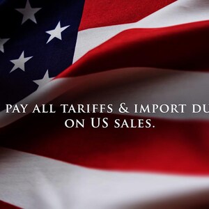 a close-up view of the American flag, with the text "We pay all tariffs & Import duties on US sales." superimposed on the image.