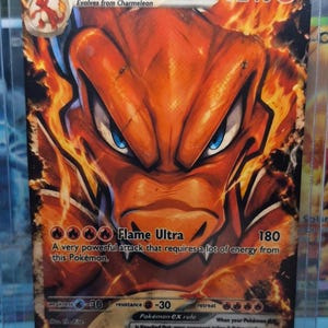 May include: A Charizard ex trading card with 240 HP, featuring a large orange dragon-like creature surrounded by flames. The card displays the text Flame Ultra, 180 damage, and includes game rules, weakness, resistance, and retreat cost icons.