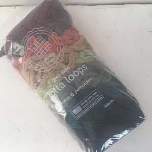 May include: A package of multi-colored yarn loops labeled "Pro Size Lotta Loops" and "Makes 6 potholders". The package also includes the text "Friendly Loom" and "Quality cotton loops made in the USA".