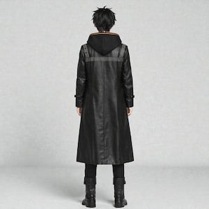 May include: A long black leather coat with a hood, featuring a grey stripe across the shoulders and orange trim on the hood. The coat has a button closure and is worn with black trousers and boots. The person is viewed from the back.