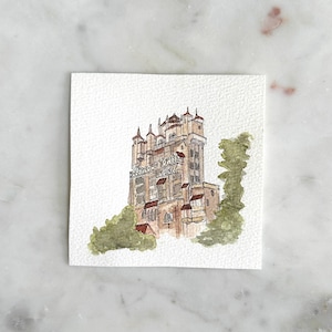May include: Watercolor painting of the Twilight Zone Tower of Terror, a popular attraction at Disney's Hollywood Studios. The building is depicted in a light brown color with red accents and the words "Twilight Zone Tower of Terror Hotel" are visible on the side.