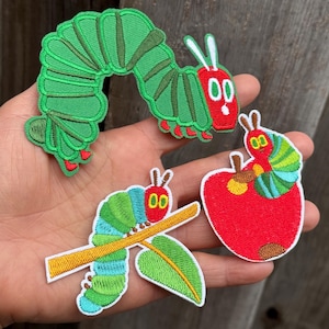 May include: Set of four embroidered patches featuring a green caterpillar, a caterpillar on a branch, a caterpillar on an apple, and a large green caterpillar. The patches have red, green, blue, and yellow accents. These patches are perfect for decorating clothing or accessories.