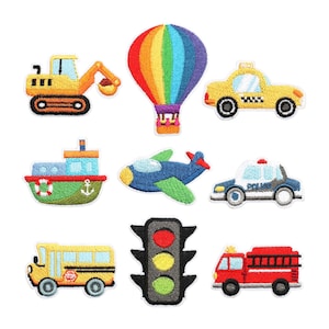 May include: A collection of embroidered patches featuring various vehicles. Includes a yellow excavator, a rainbow hot air balloon, a yellow taxi, a blue and green airplane, a red and green boat, a police car, a yellow school bus, a traffic light, and a red fire truck.