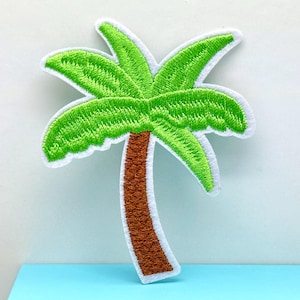May include: An embroidered patch of a green palm tree with a brown trunk. The patch is on a white background.