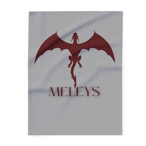 May include: A gray throw blanket with a red dragon silhouette and the word "MELEYS" printed in red.
