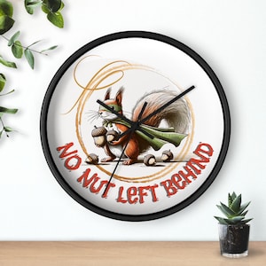 May include: A black and white wall clock with a white background and a cartoon squirrel wearing a green cape and holding nuts. The text "No Nut Left Behind" is written in red around the squirrel.