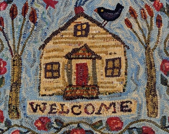 May include: A rectangular rug featuring a hooked fiber design of a tan house with a red door, a black bird on the roof, and two trees with brown foliage. The word WELCOME is centered below the house, surrounded by red flowers and a light blue background.