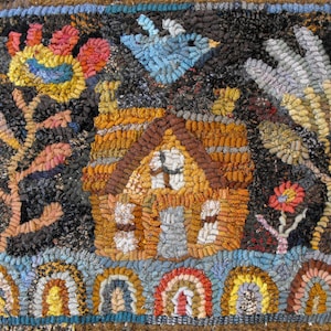 May include: A colorful rug hooking with a brown house, blue bird, and flowers in shades of red, yellow, and blue. The rug is framed with a blue border and has a row of rainbow arches at the bottom.