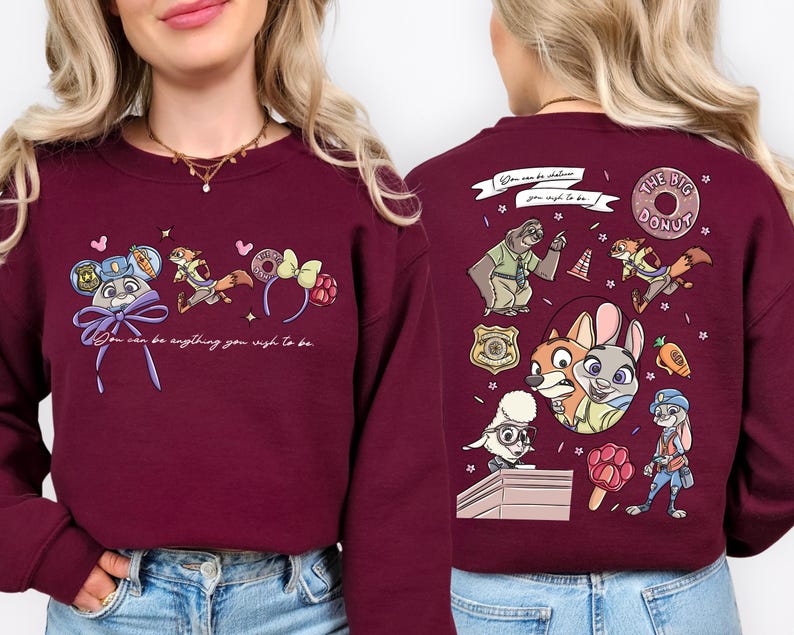 a woman wearing a burgundy sweater with various cartoon characters and designs on the back.