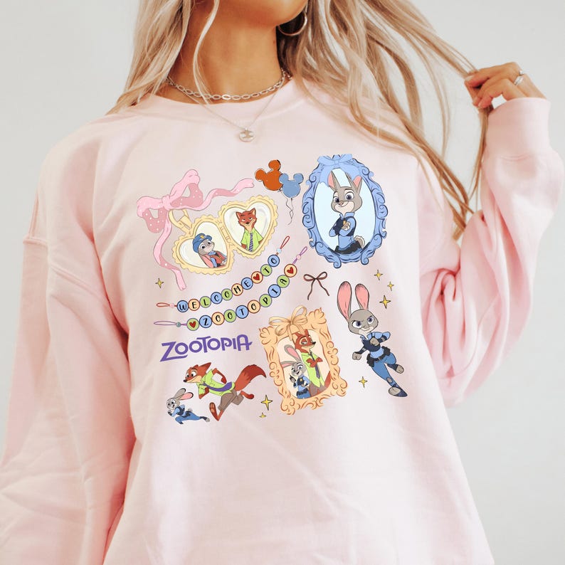 A woman wearing a pink sweatshirt with various cartoon animal characters and a pink bow on it.