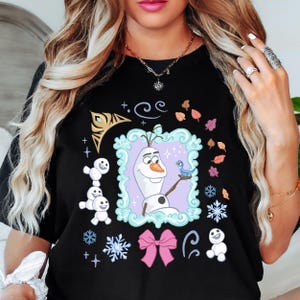 A woman wearing a black t-shirt with a graphic design featuring characters from the Disney movie Frozen.