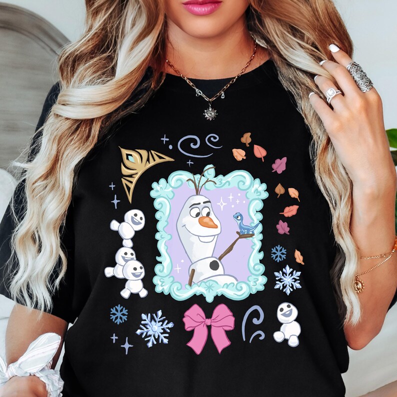 A woman wearing a black t-shirt with a graphic design featuring characters from the Disney movie Frozen.