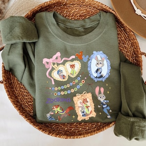 A green t-shirt with various cartoon animal characters and a wicker basket containing additional clothing items.