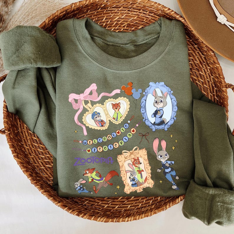 A green t-shirt with various cartoon animal characters and a wicker basket containing additional clothing items.