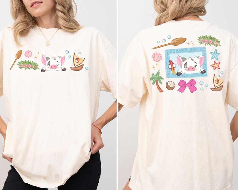 A woman wearing a white t-shirt with a cartoon pig design and various colorful illustrations on the back.