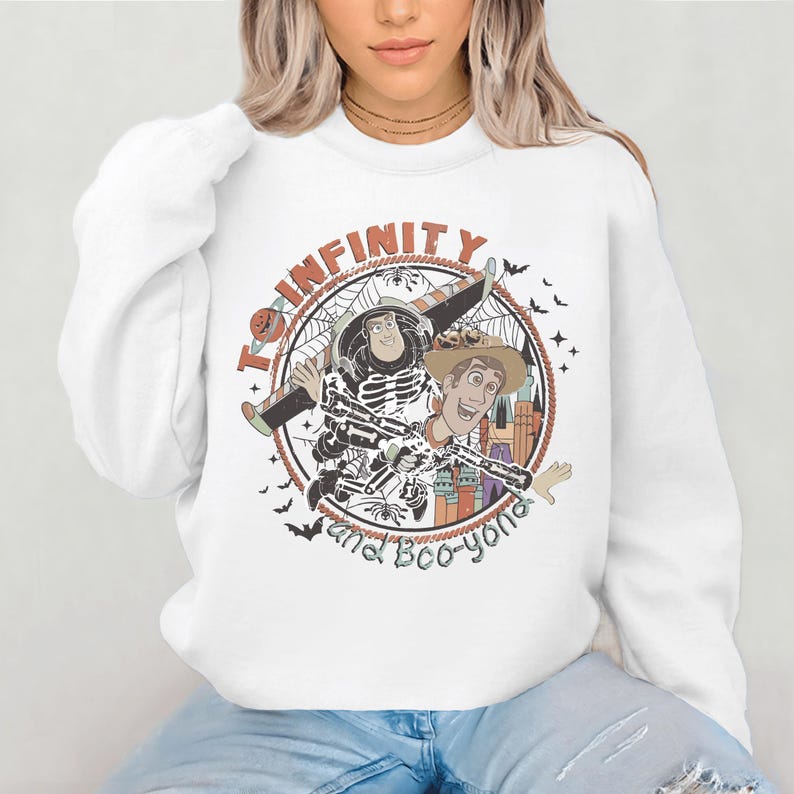 A woman wearing a white sweatshirt with a graphic design featuring characters from the Toy Story franchise.