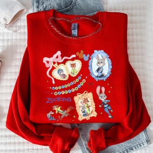A red sweatshirt with various cartoon characters and designs, including a rabbit, a fox, and other animals, along with a chain around the neck.