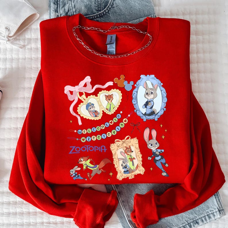 A red sweatshirt with various cartoon characters and designs, including a rabbit, a fox, and other animals, along with a chain around the neck.