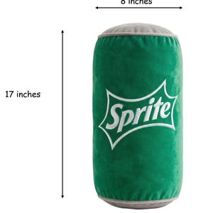 A green plush toy resembling a can of Sprite, with the word "Sprite" printed on it. The toy is described as being 8 inches tall and 17 inches wide.