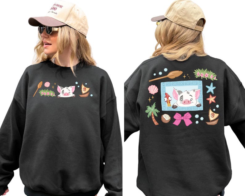 A woman wearing a black sweatshirt with a cartoon pig design and various other decorative elements on the back.