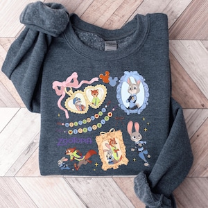 A gray sweatshirt with various cartoon animal characters and a mirror on the front.