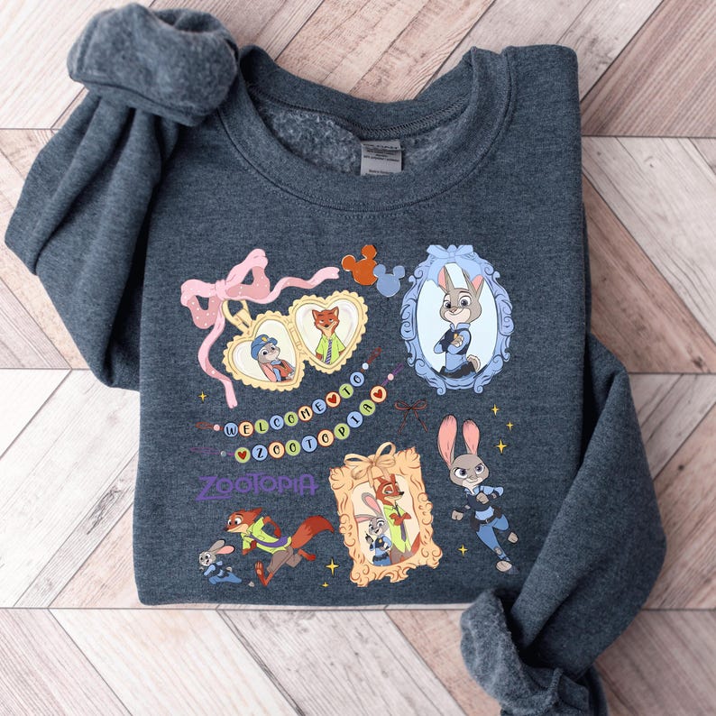 A gray sweatshirt with various cartoon animal characters and a mirror on the front.