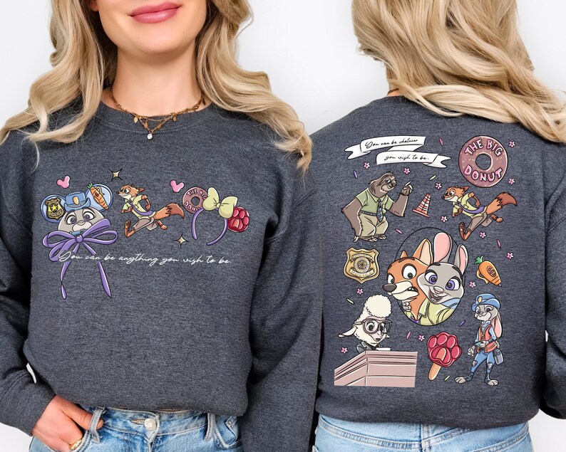 a woman wearing a gray sweatshirt with a colorful and whimsical design on the back.