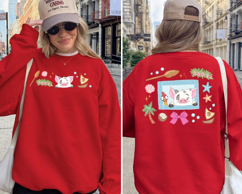 A woman wearing a red sweater with a pig design and various other decorative elements, including a palm tree, starfish, and other whimsical illustrations.