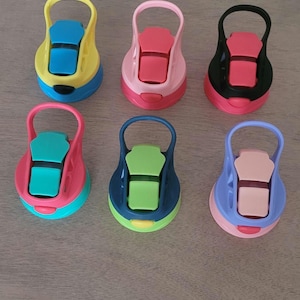 May include: Six colorful water bottle lids in various shades, including yellow, pink, blue, and green. Each lid has a flip-top design with a handle for easy carrying. The lids are made of plastic.