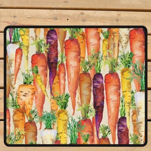 May include: Rectangular doormat featuring a watercolor illustration of various carrots in shades of orange, yellow, and purple with green tops. The carrots are arranged closely together against a cream-colored background, creating a vibrant and colorful design.