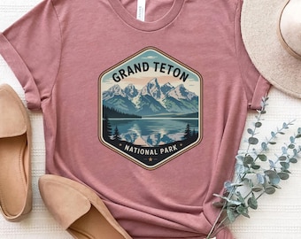 Grand Teton National Park Tee With Snowy Peaks, Lake Reflection, Forest View, and Rugged Wilderness Design