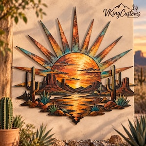 May include: A metal wall art piece featuring a desert sunset scene with a large sun, radiating rays, cacti, and rock formations. The design incorporates warm orange, yellow, and teal tones with a weathered finish. The text VKingCustoms is visible.
