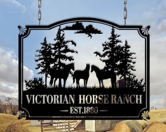 May include: Black metal sign with the words "Victorian Horse Ranch" and "EST.1880". The sign features silhouettes of three horses, trees, and a cloudy sky. The sign is suspended from chains.